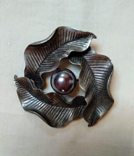 Broche bisuteria con tres hojas y perla central color plata vieja.Nuevo