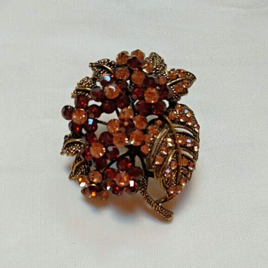 Broche bisuteria tipo vintage  con piedras tonos marrones.Nuevo